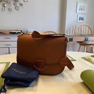 Brand new Cole Haan purse with storage bag(